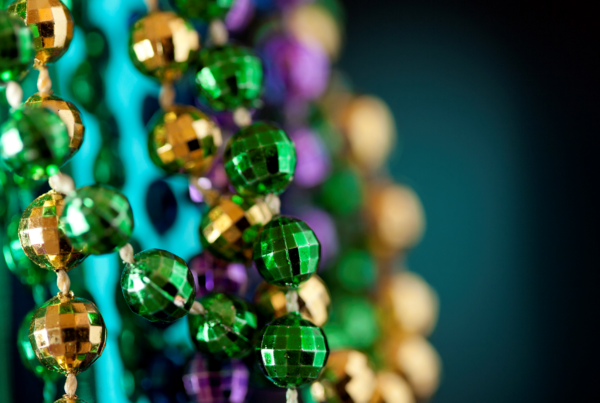 Colorful Mardi Gras celebration with beads, cocktails, and festive nightlife setting